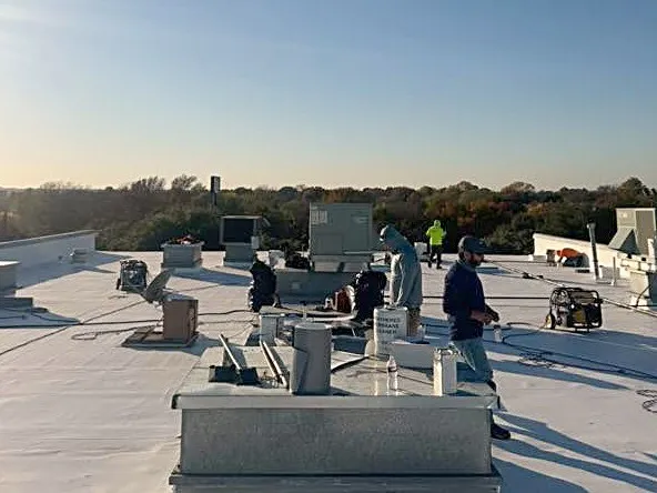 The same roof with a new white membrane and the GLC crew at work