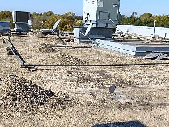 The Concentra Urgent Care flat roof before replacement, with the old gravel surface torn up